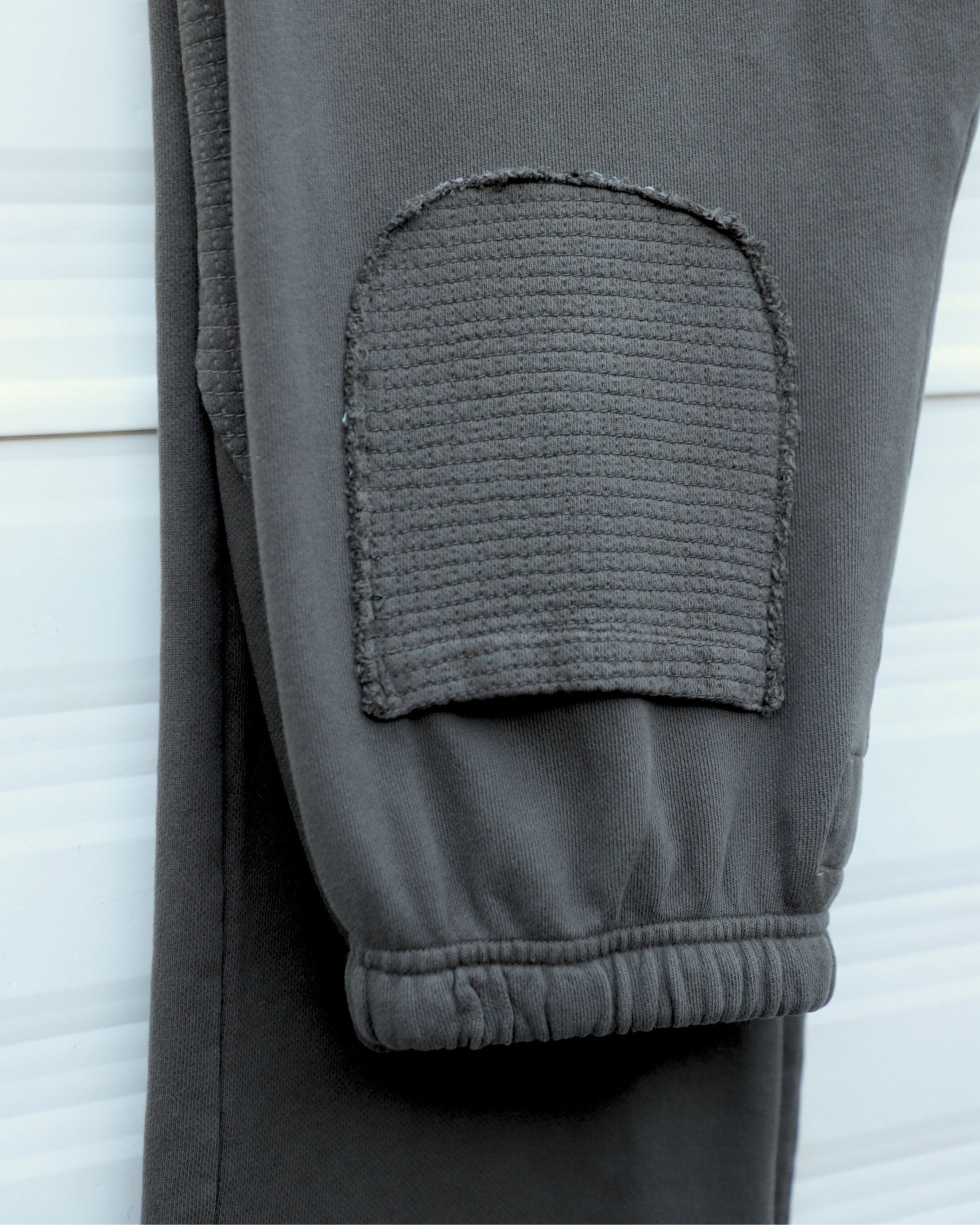 Back pocket with matching crosshatch fabric and tonal stitching.
