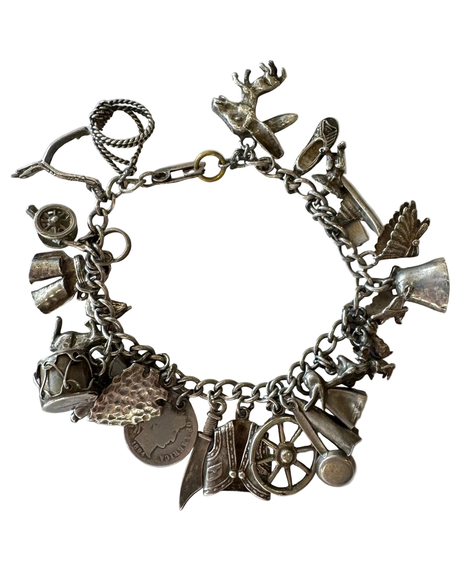 Silver charm bracelet with various charms on a white background