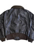 Back view of 1964 Schott Bros. USN G-1 flight jacket in dark seal brown leather with shearling collar, knit waistband, and back panel seam, on white background.