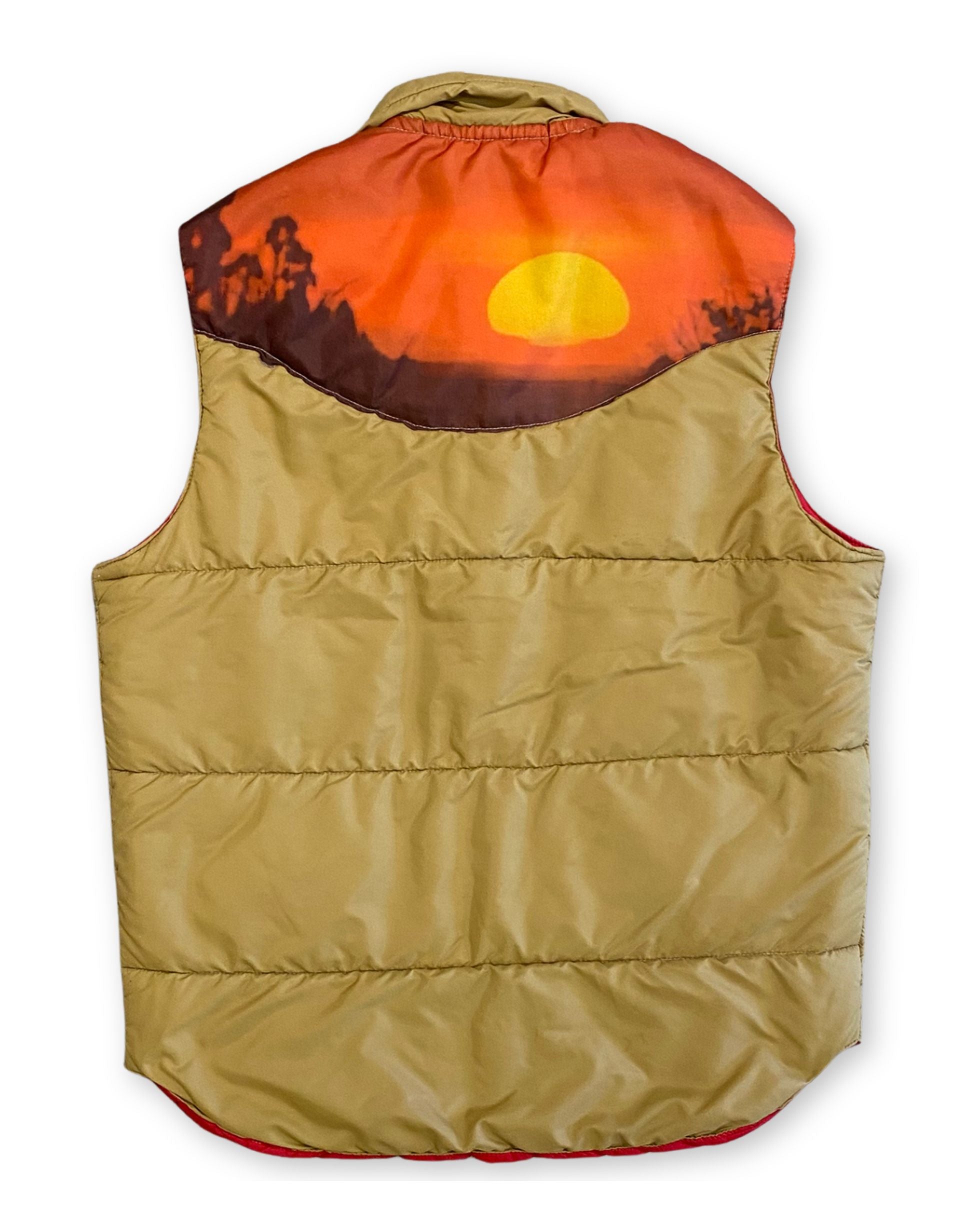 Back view of a tan 1970s Miller Outer Wear nylon puffer vest with a scenic orange, brown, and golden sunrise yoke across the shoulders.
