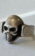 Silver skull ring on a white background.