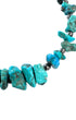 Close-up of blue and blue-green turquoise nuggets with natural brown matrix separated by darkened round sterling silver beads.
