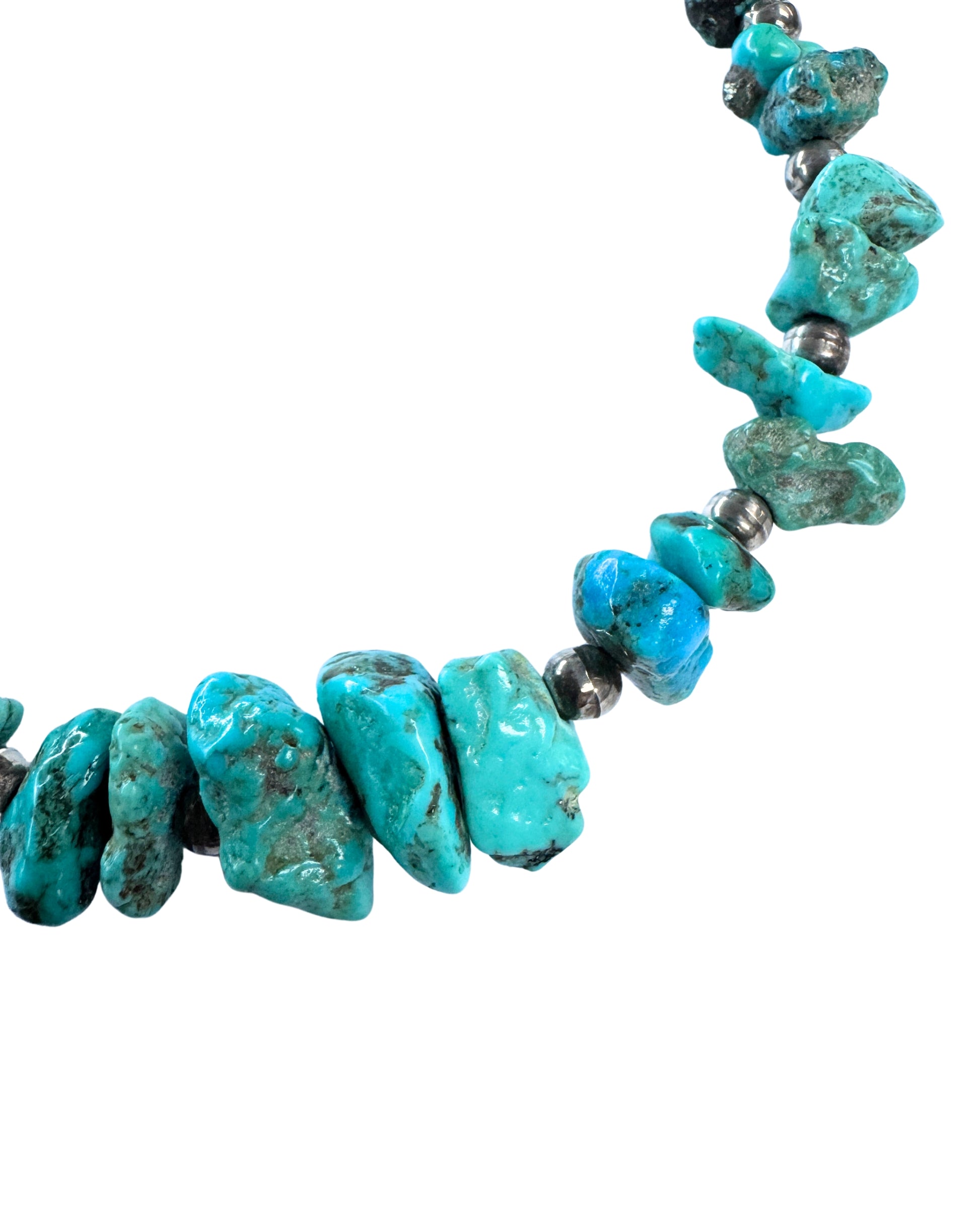 Close-up of blue and blue-green turquoise nuggets with natural brown matrix separated by darkened round sterling silver beads.