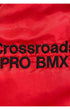 Close-up of a red satin or silk fabric with black embroidered text reading 'Crossroads PRO BMX'.