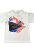 Front of vintage 1987 Vietnam Veterans Welcome Home concert T-shirt featuring patriotic graphics and musician lineup.
