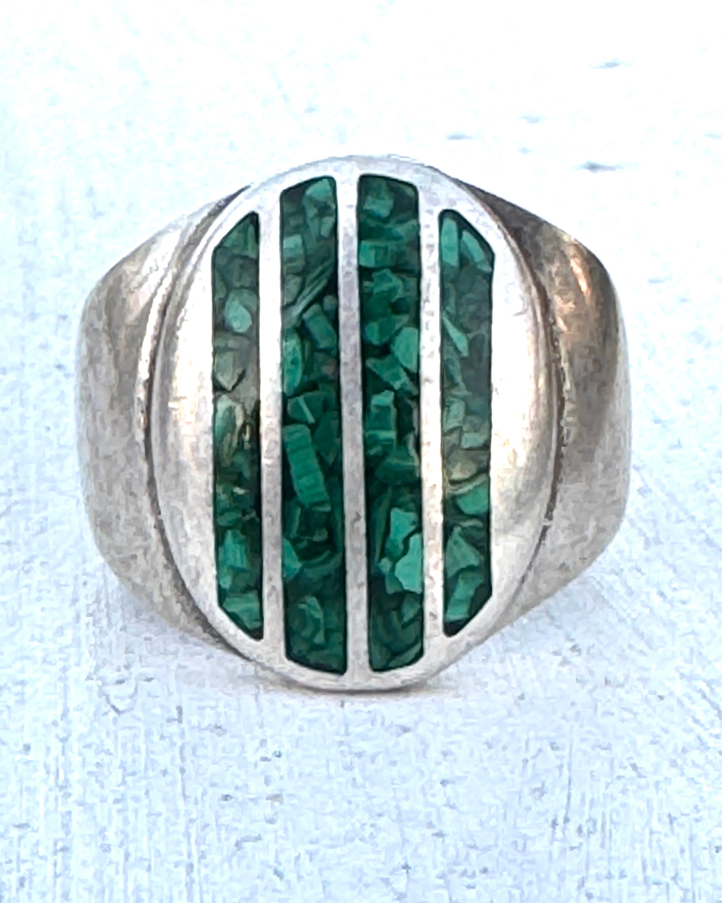 Vintage sterling silver ring with vertical turquoise inlay on oval face.