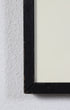 Black picture frame on a textured white wall