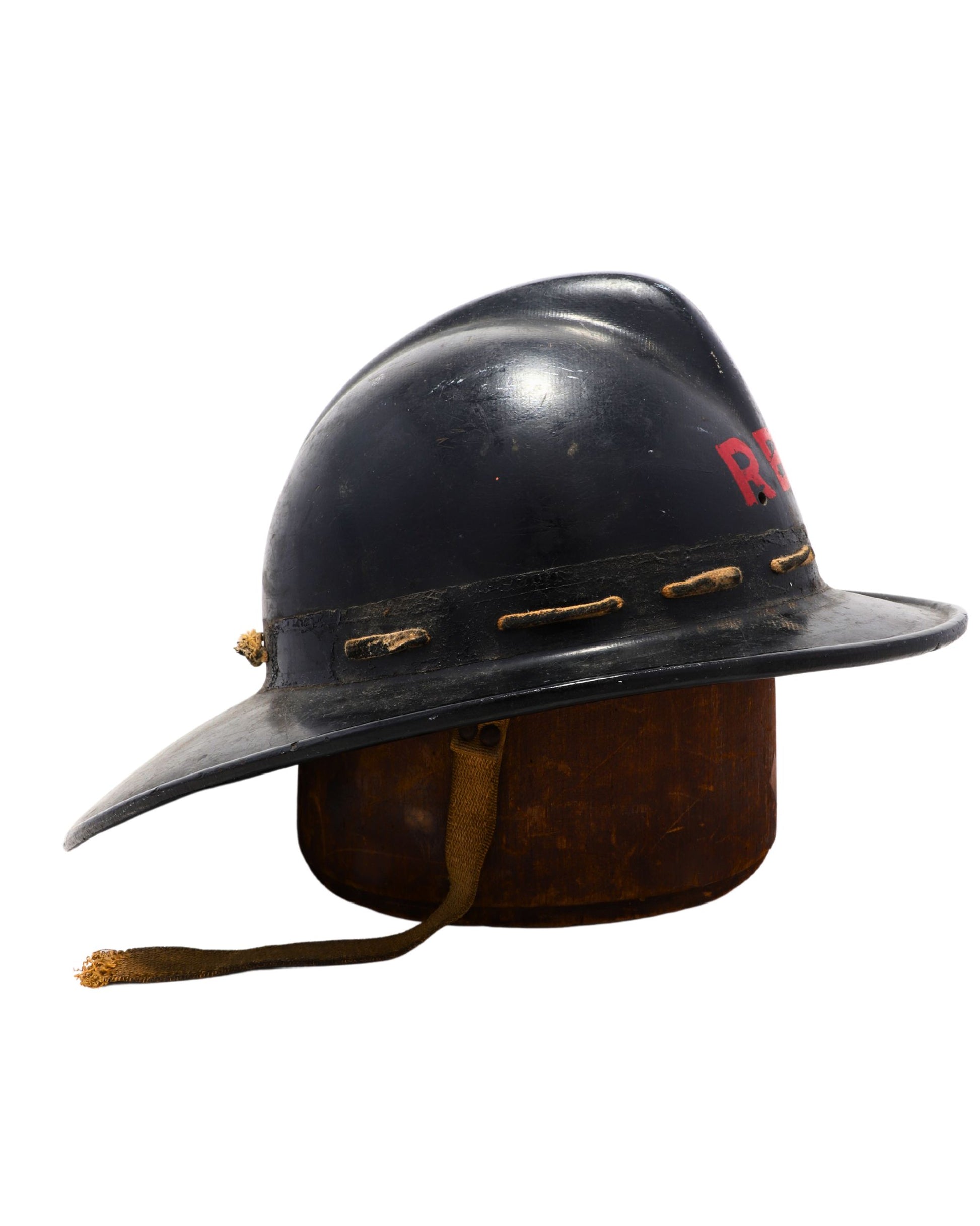 Side view of black vintage firefighter helmet with chin strap.