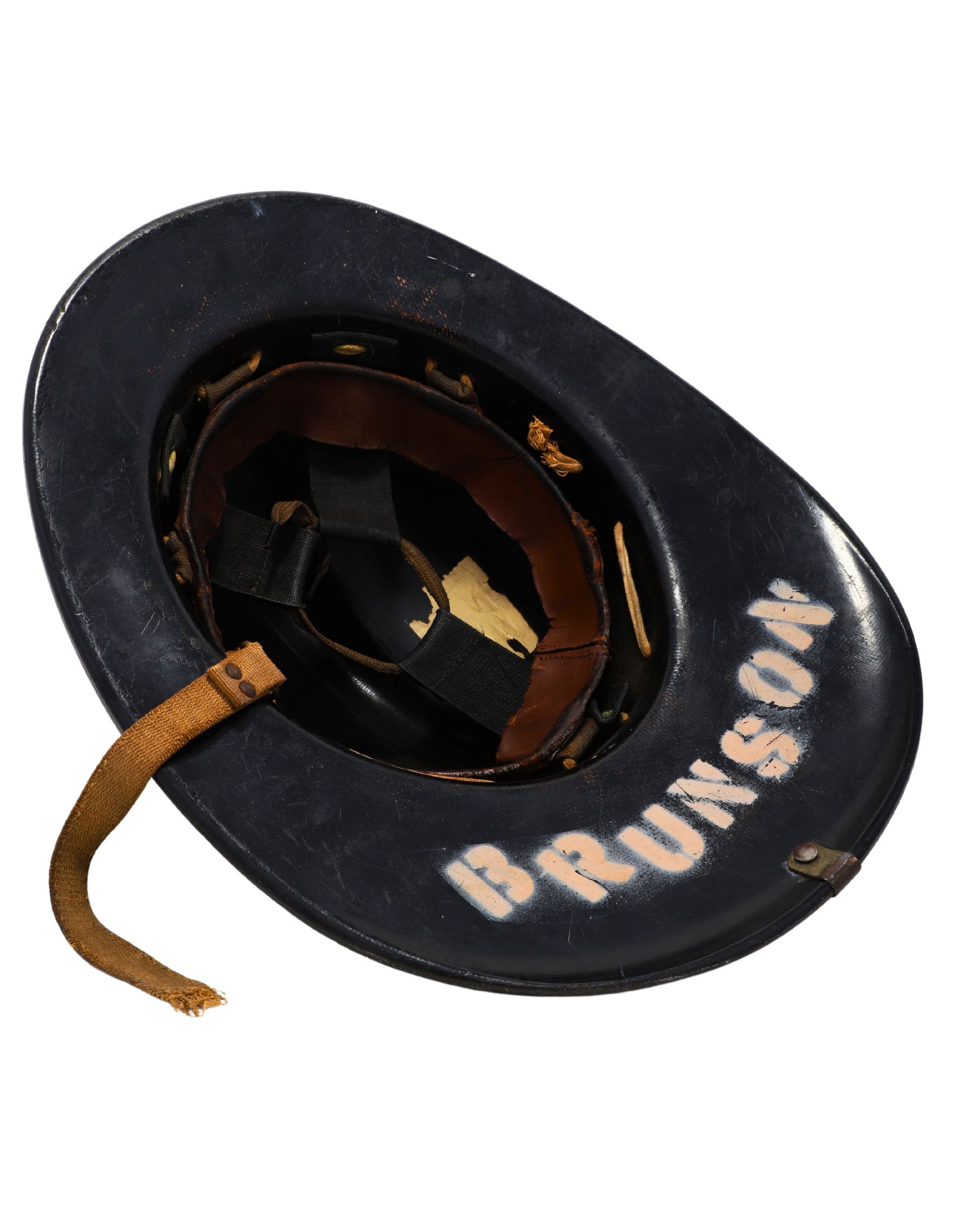 Interior of helmet showing leather liner and name “BRUNSON”.
