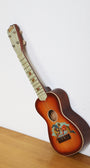 1920s Touchdown ukulele with football player graphic and faux pearl fretboard.