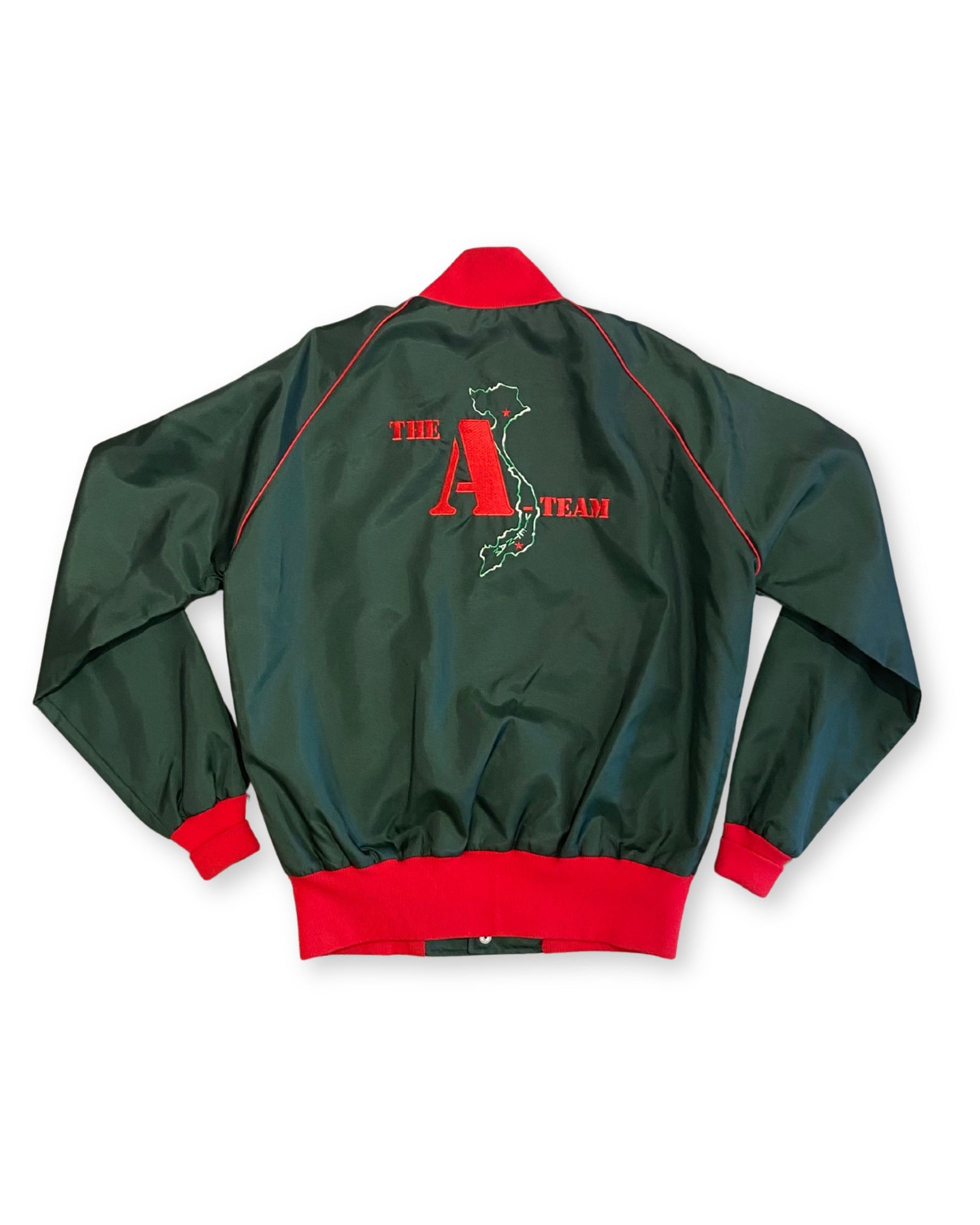 Back view of a 1980s The A-Team crew jacket in deep green with red trim and an embroidered Vietnam-map graphic.