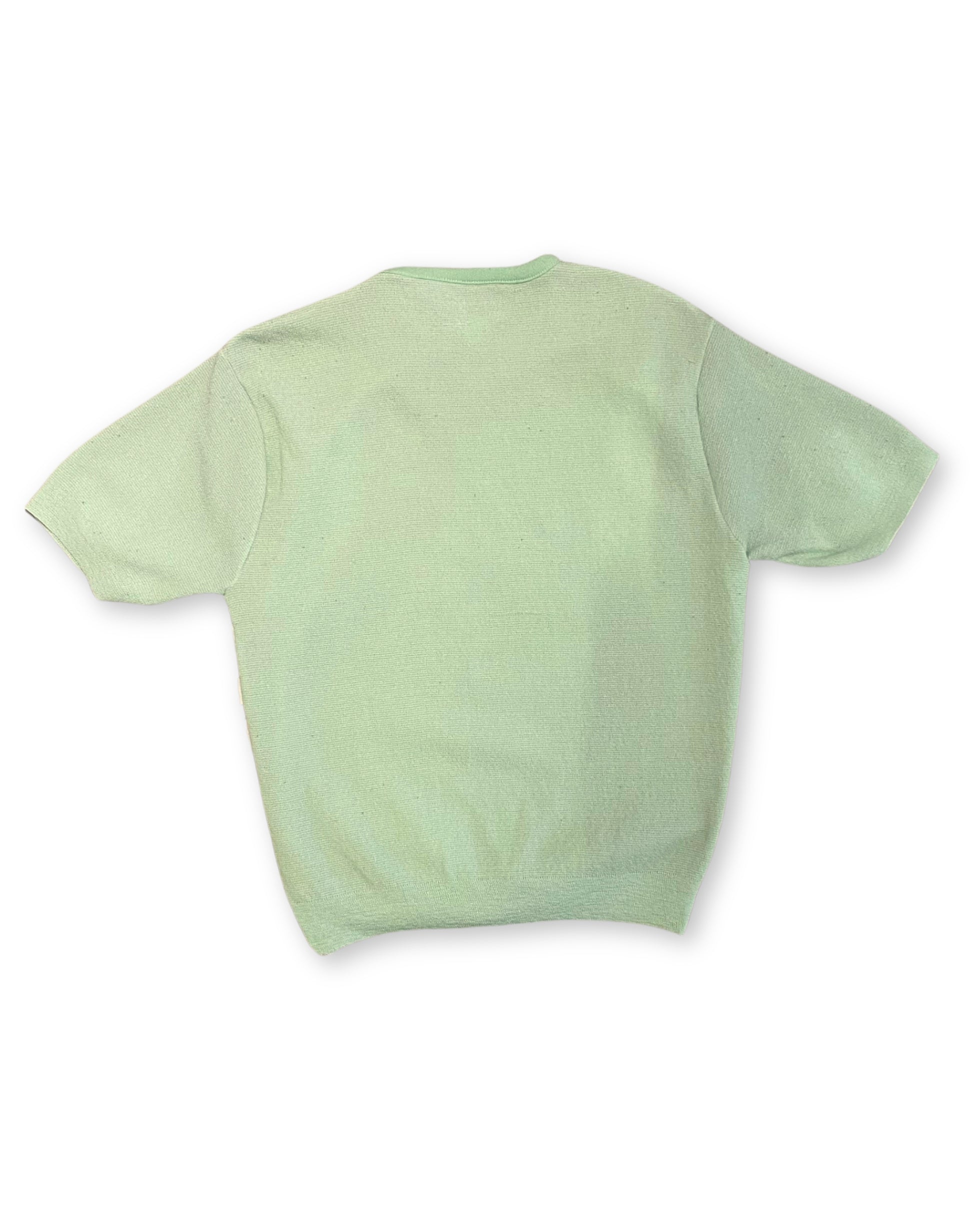 Back view of vintage mint green knit shirt with solid back and short sleeves.
