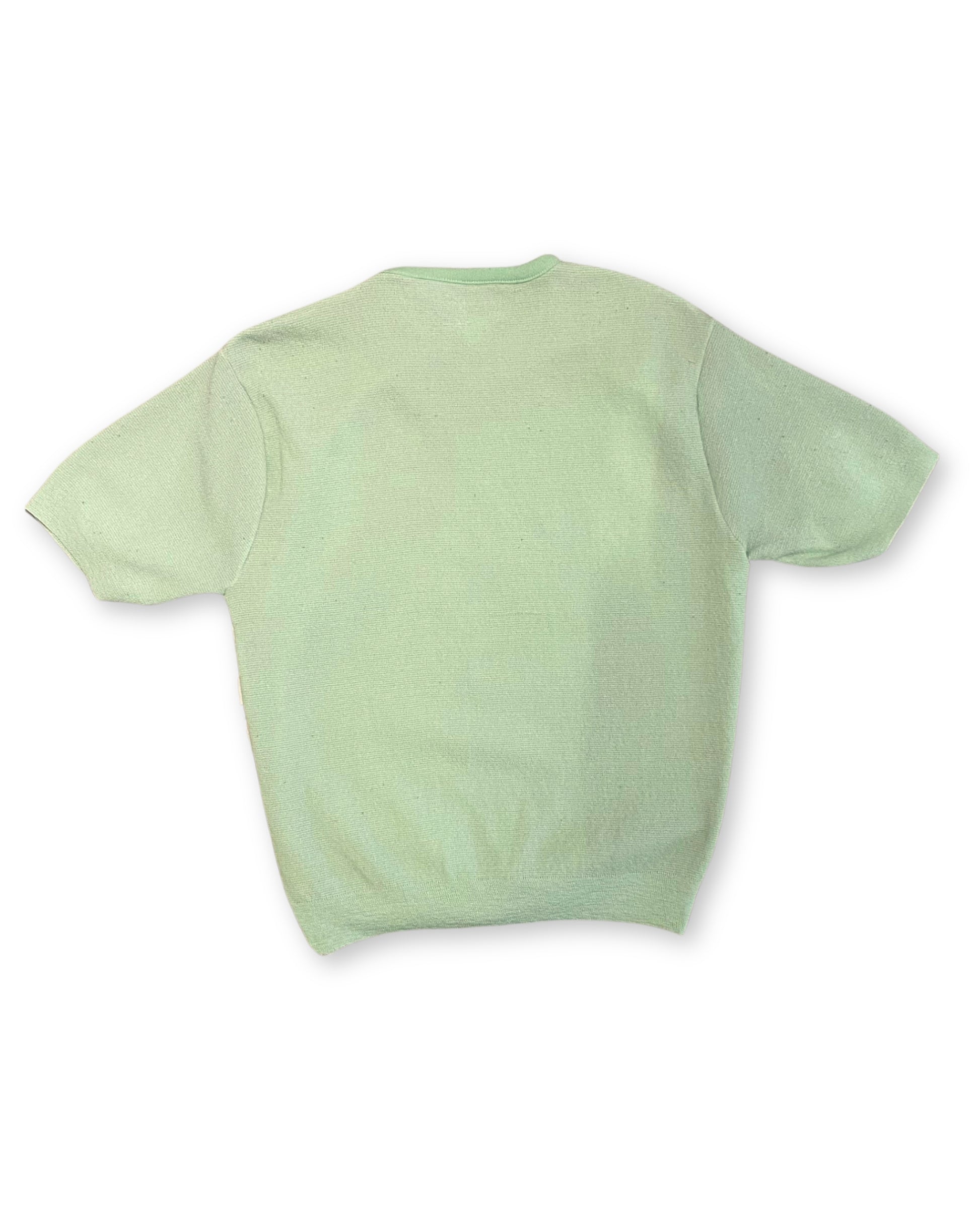 Back view of vintage mint green knit shirt with solid back and short sleeves.
