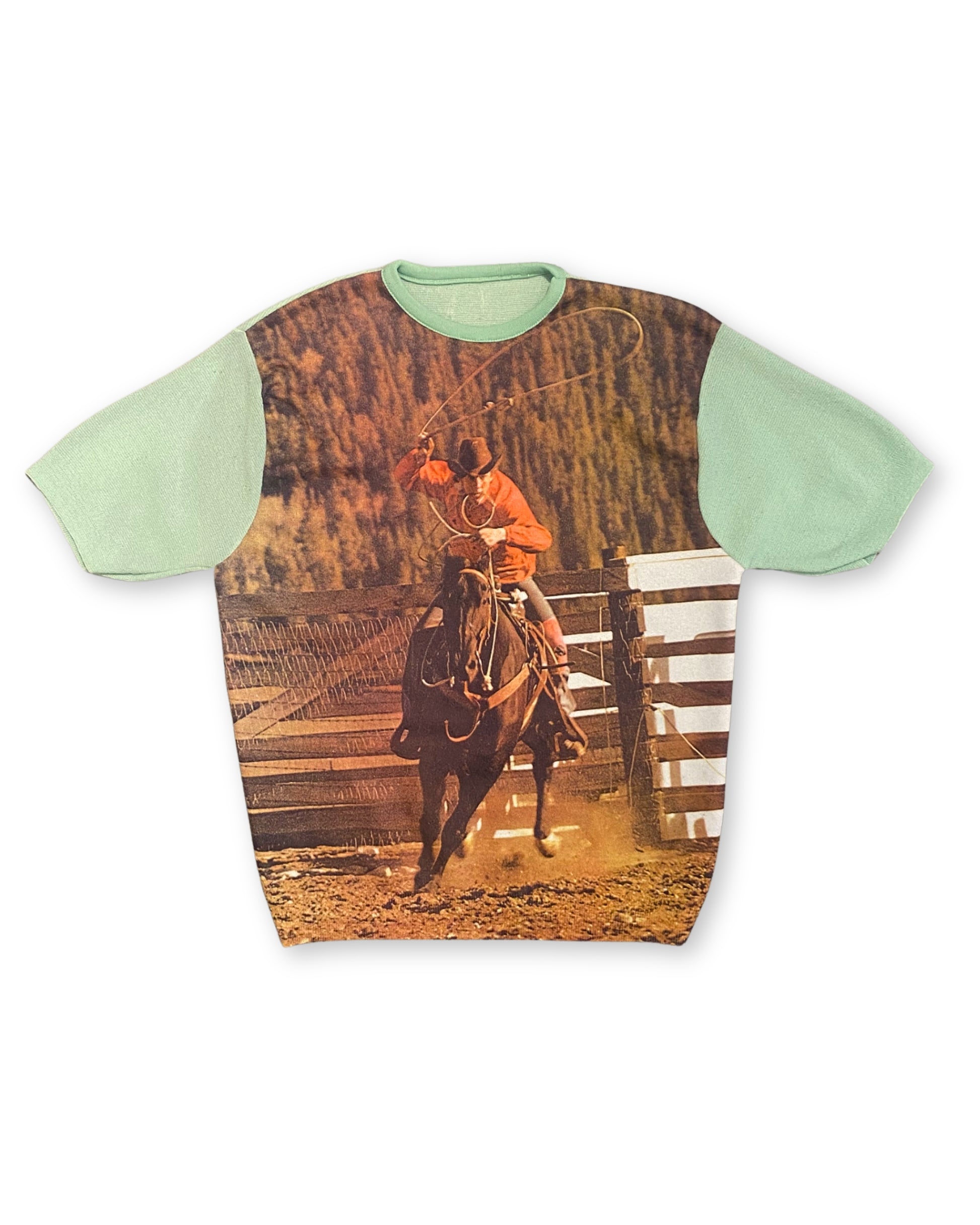 Front view of circa 1970s mint green knit shirt with full-front cowboy rodeo photo print.