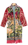 Artisan tapestry coat with stag and deer design, red velvet sleeves, and fringe hem. Handmade one-of-a-kind outerwear in vivid colors.