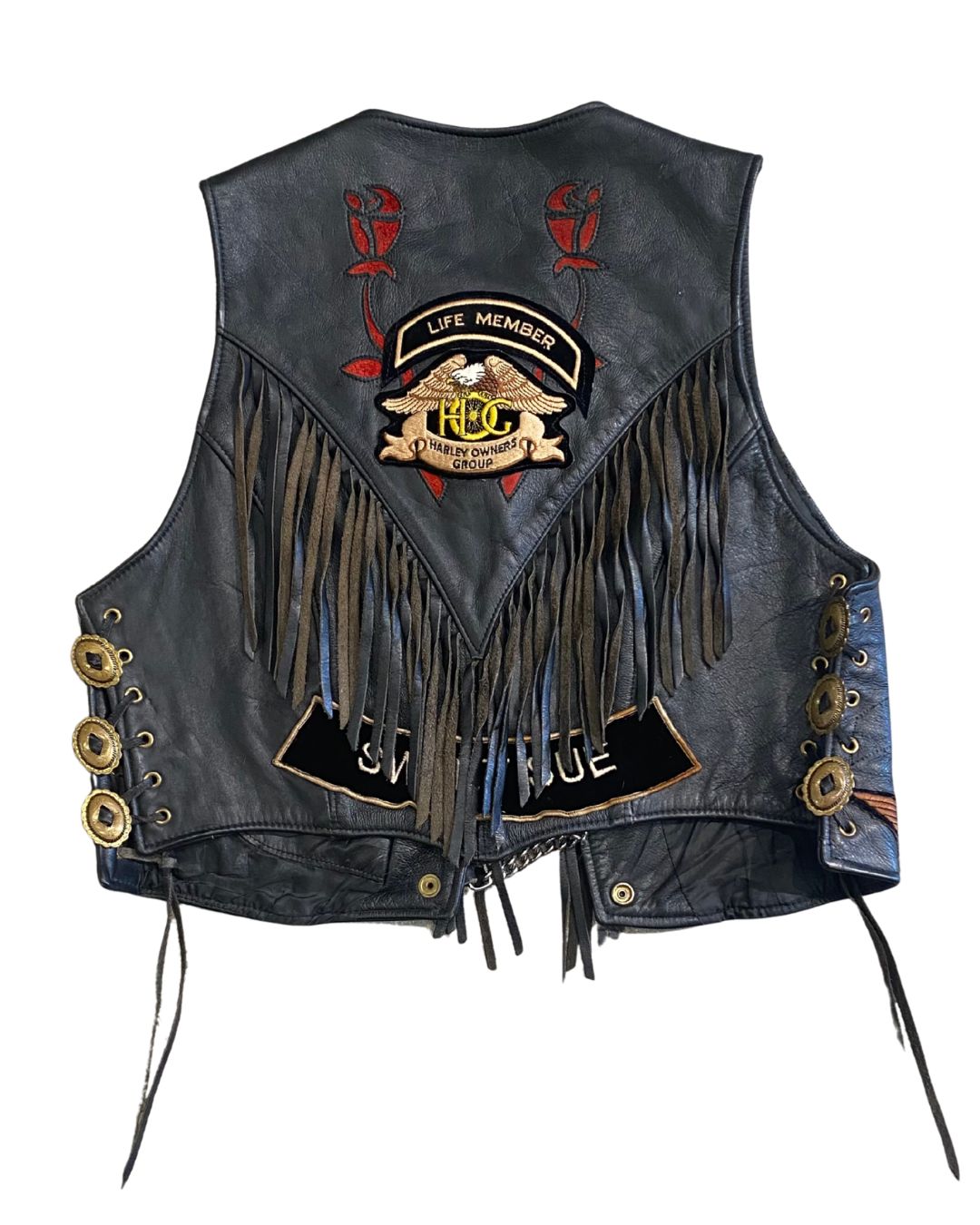 Back view of Harley Davidson vest with fringe, H.O.G. Life Member patch, and name tag.