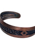 Angled view of vintage Bell Trading Post copper cuff bracelet showing darkened recessed design and warm copper finish.
