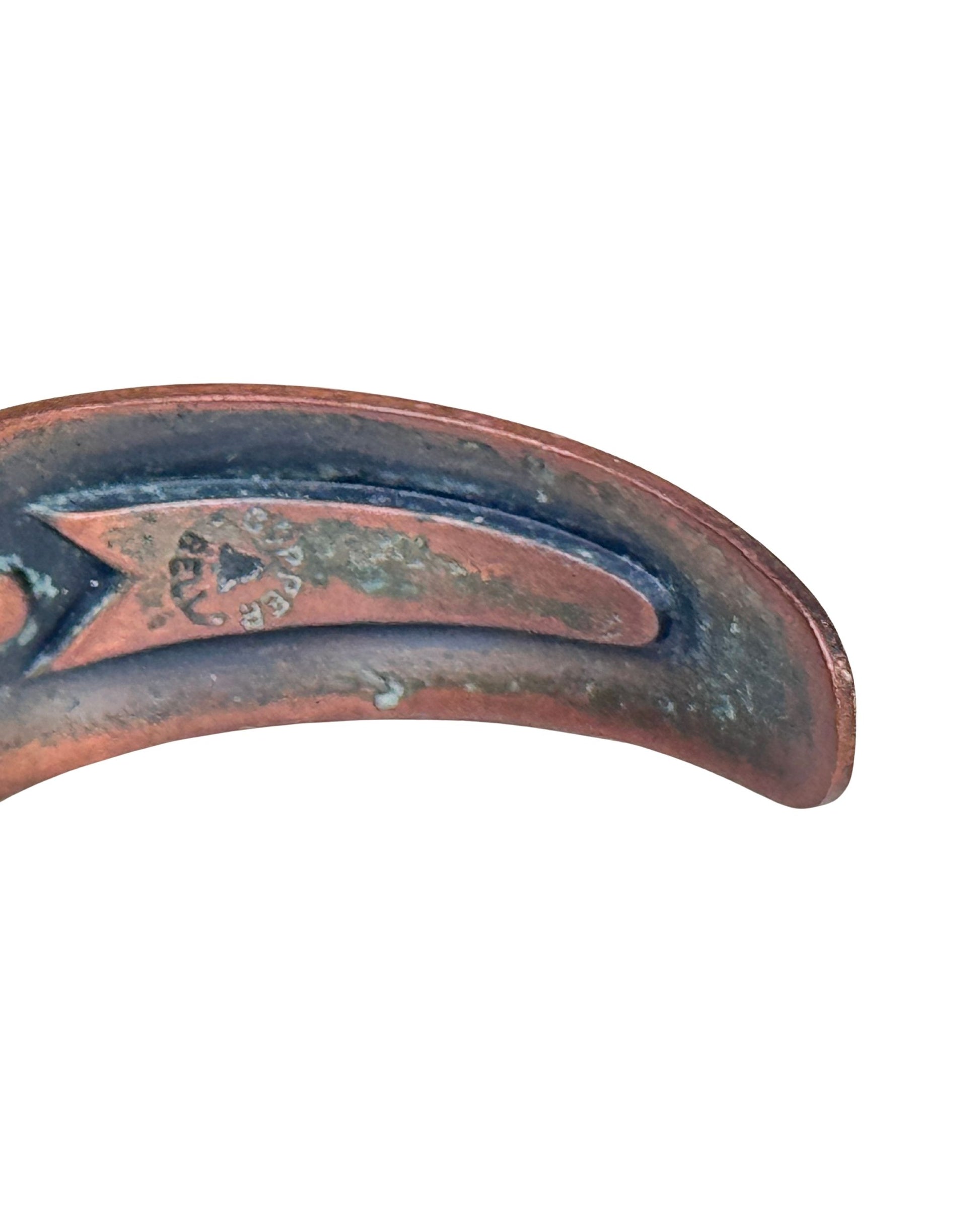 Interior view of vintage Bell Trading Post copper cuff bracelet showing maker’s stamp and natural oxidation.