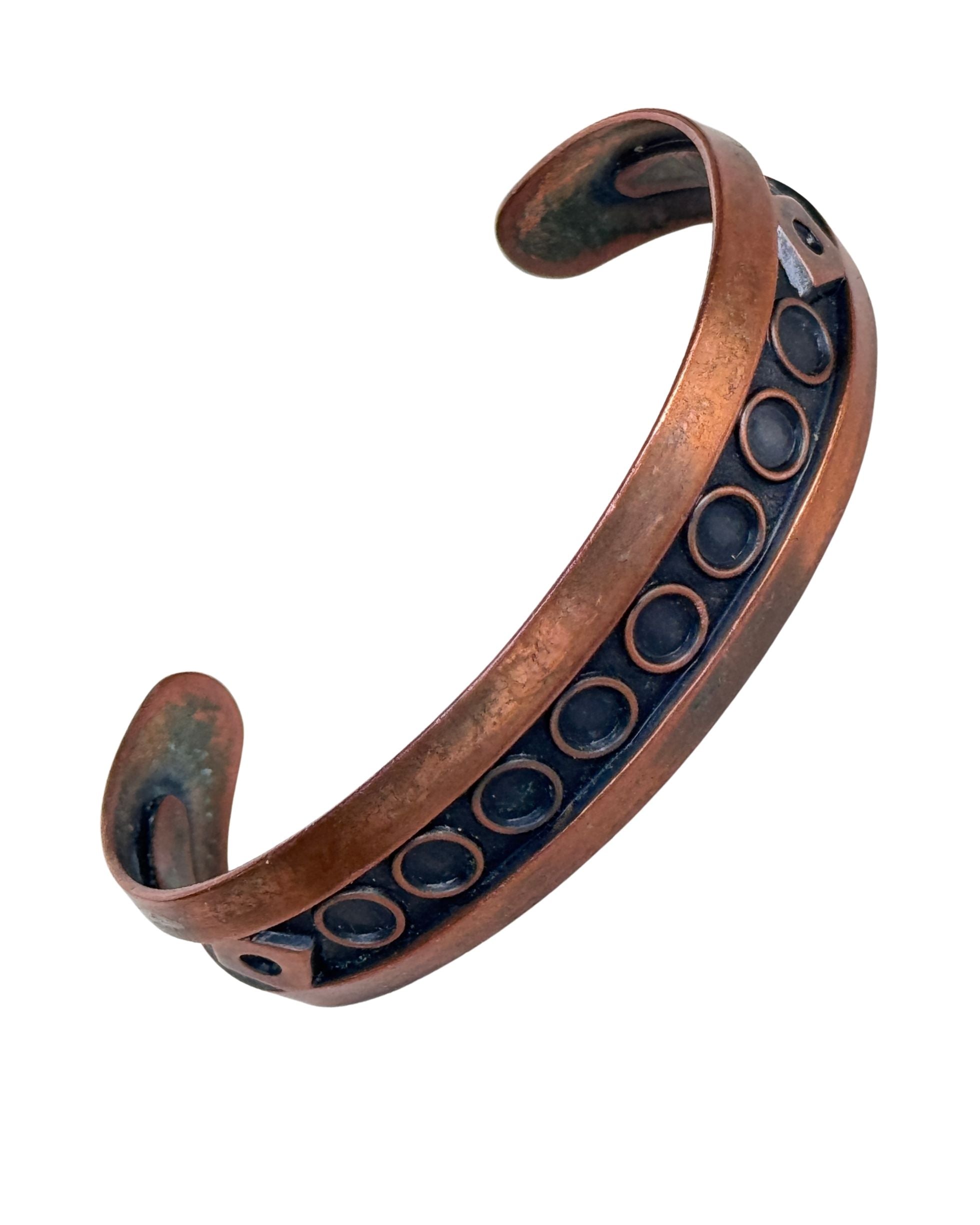 Front view of vintage 1930s Bell Trading Post copper cuff bracelet with Southwestern circle motif and aged patina.