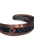 Angled view of vintage Bell Trading Post copper cuff bracelet showing darkened recessed design and warm copper finish.
