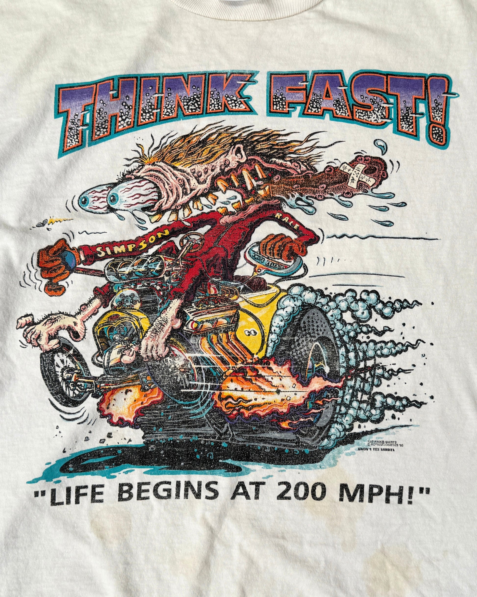 Close-up of the colorful “Think Fast!” graphic showing a wild-eyed monster driving a smoking dragster above the words “Life Begins at 200 MPH!”

