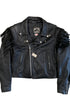 Front view of a black leather motorcycle jacket with asymmetrical zipper, silver hardware, and long fringe along the shoulders and sleeves.
