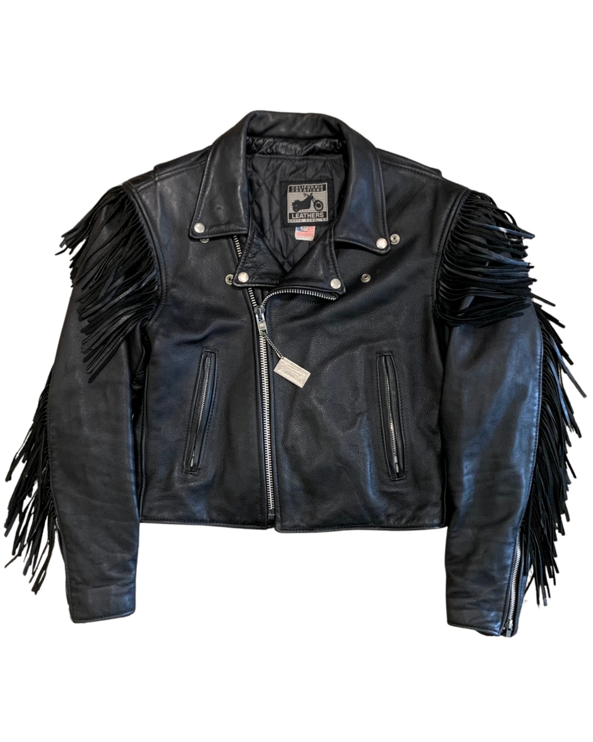 Front view of a black leather motorcycle jacket with asymmetrical zipper, silver hardware, and long fringe along the shoulders and sleeves.