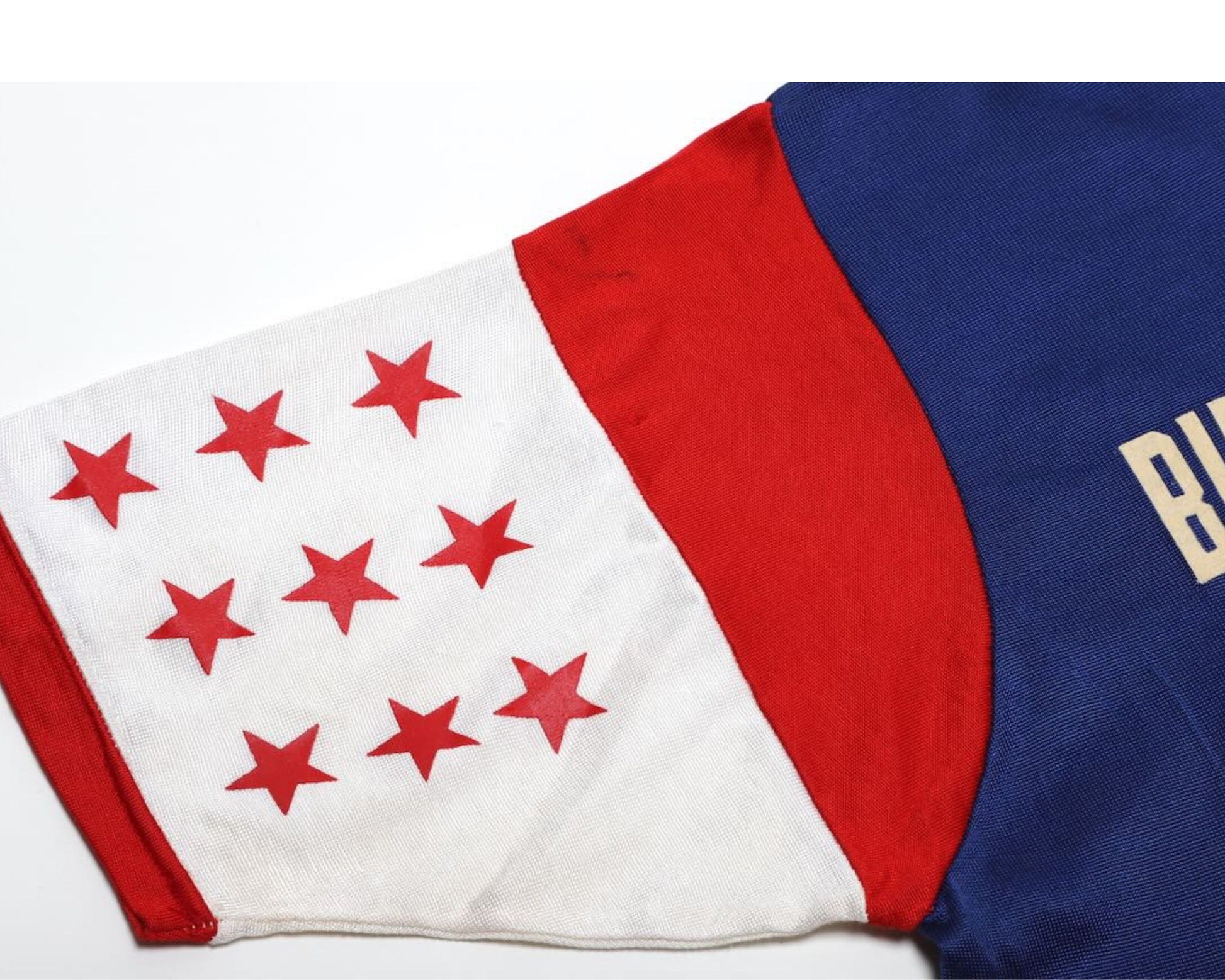 Detail  view of stars on sleeve of vintage Budd Friedman’s Improvisation Broadway Show League jersey.