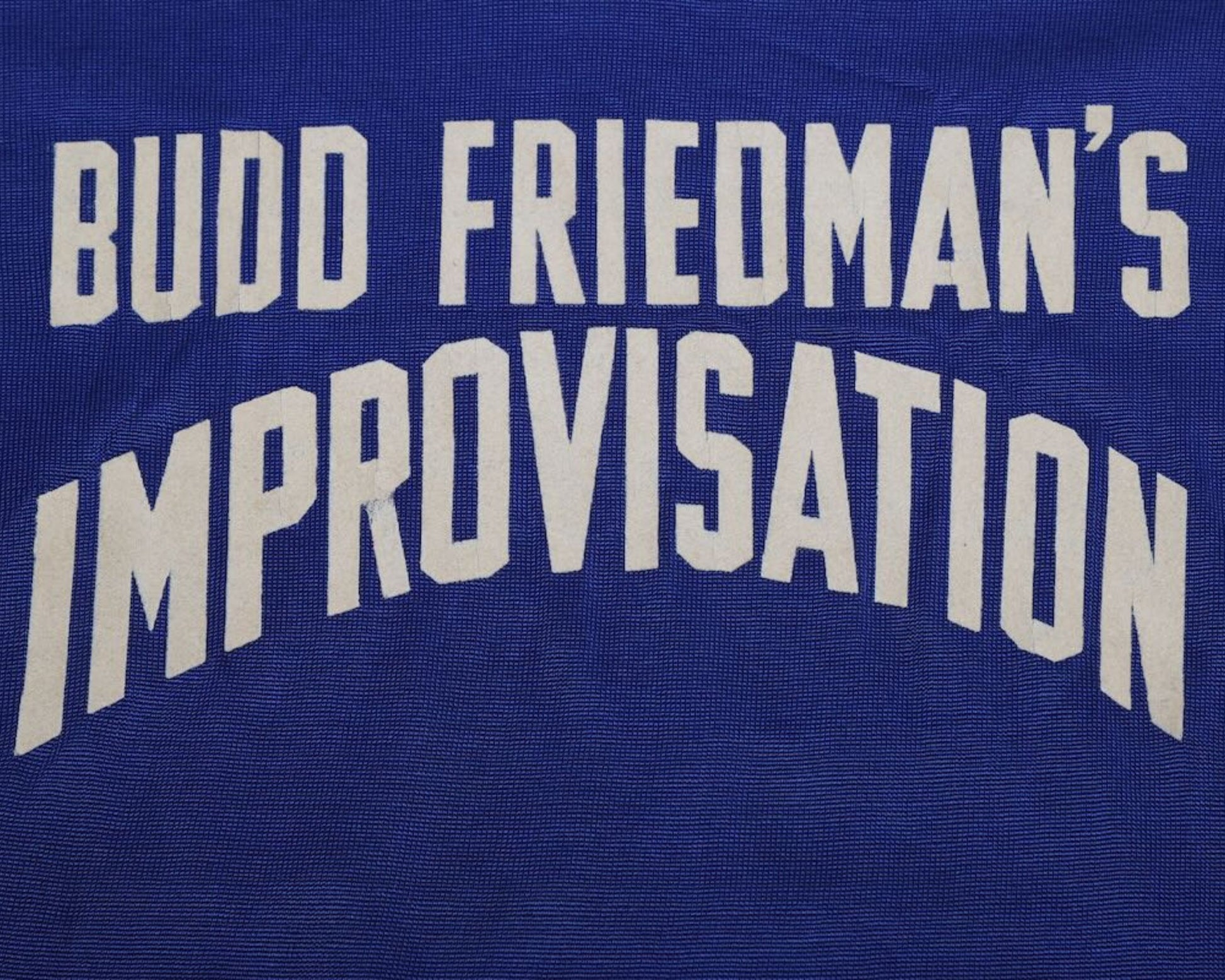 Detail  view of : Budd Friedman’s Improvisation tyoe on Broadway Show League jersey.