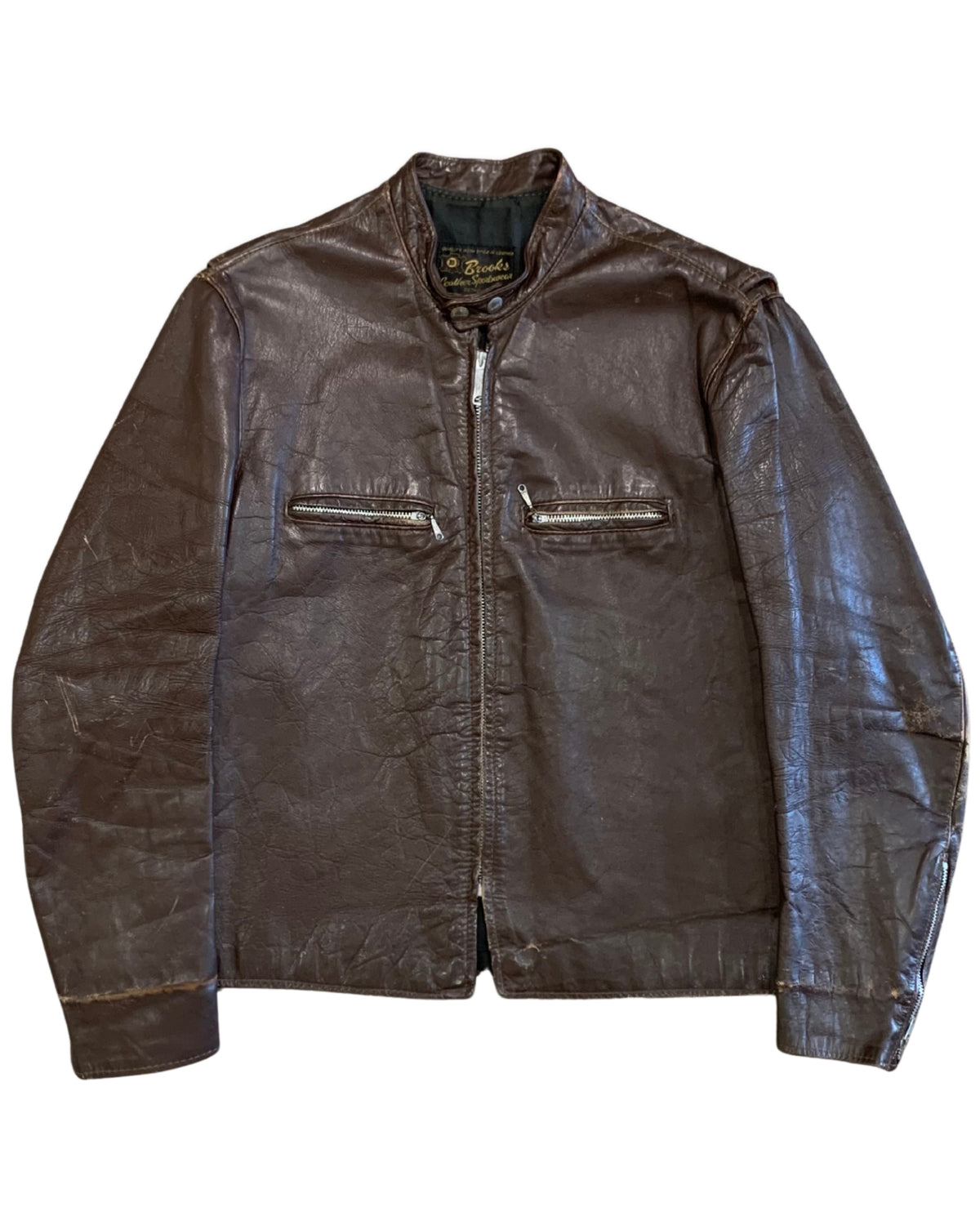 Front view of a dark brown Brooks leather café racer motorcycle jacket with stand collar, front zipper, and two horizontal zippered chest pockets.