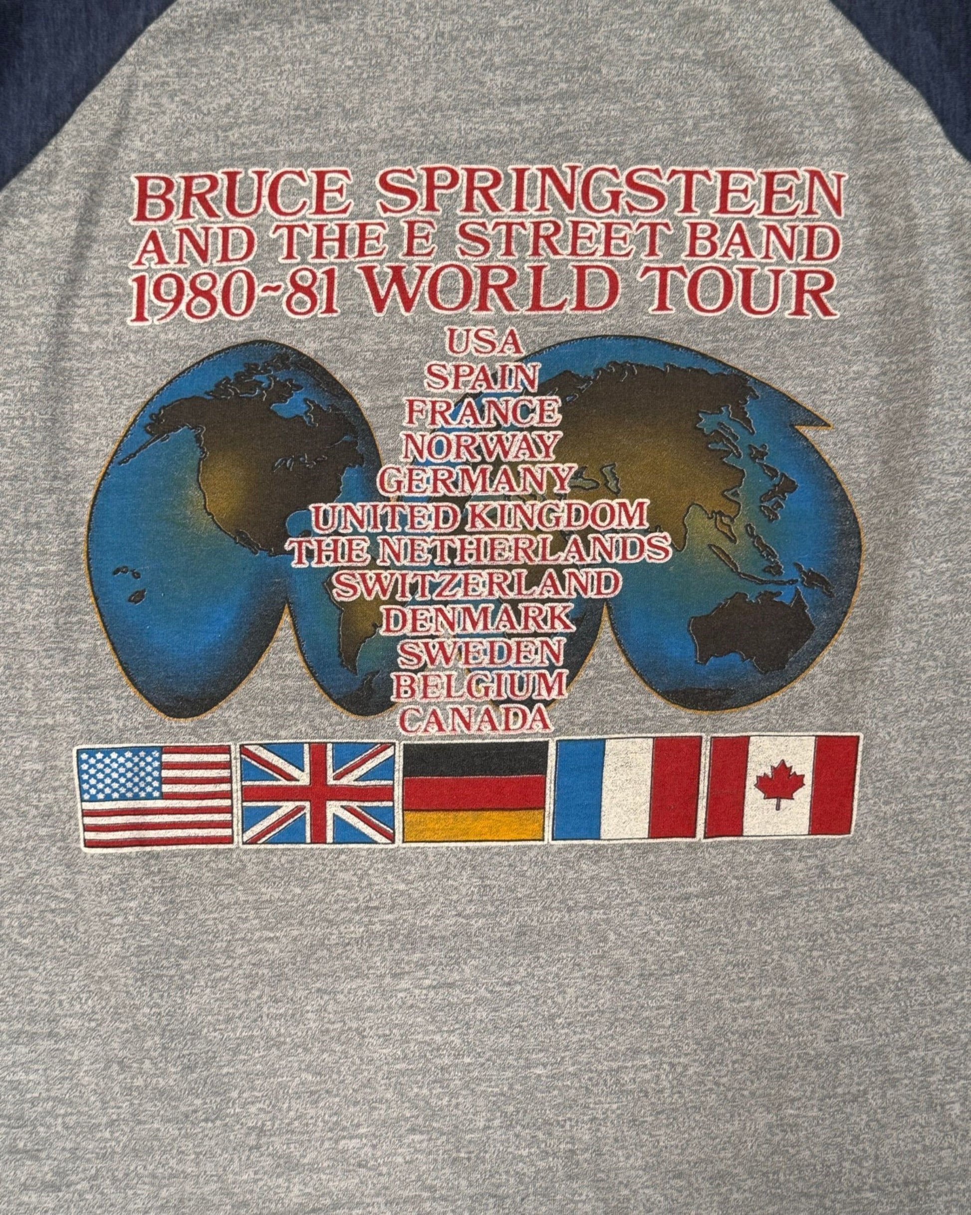 Close-up of world tour locations and flags on back.