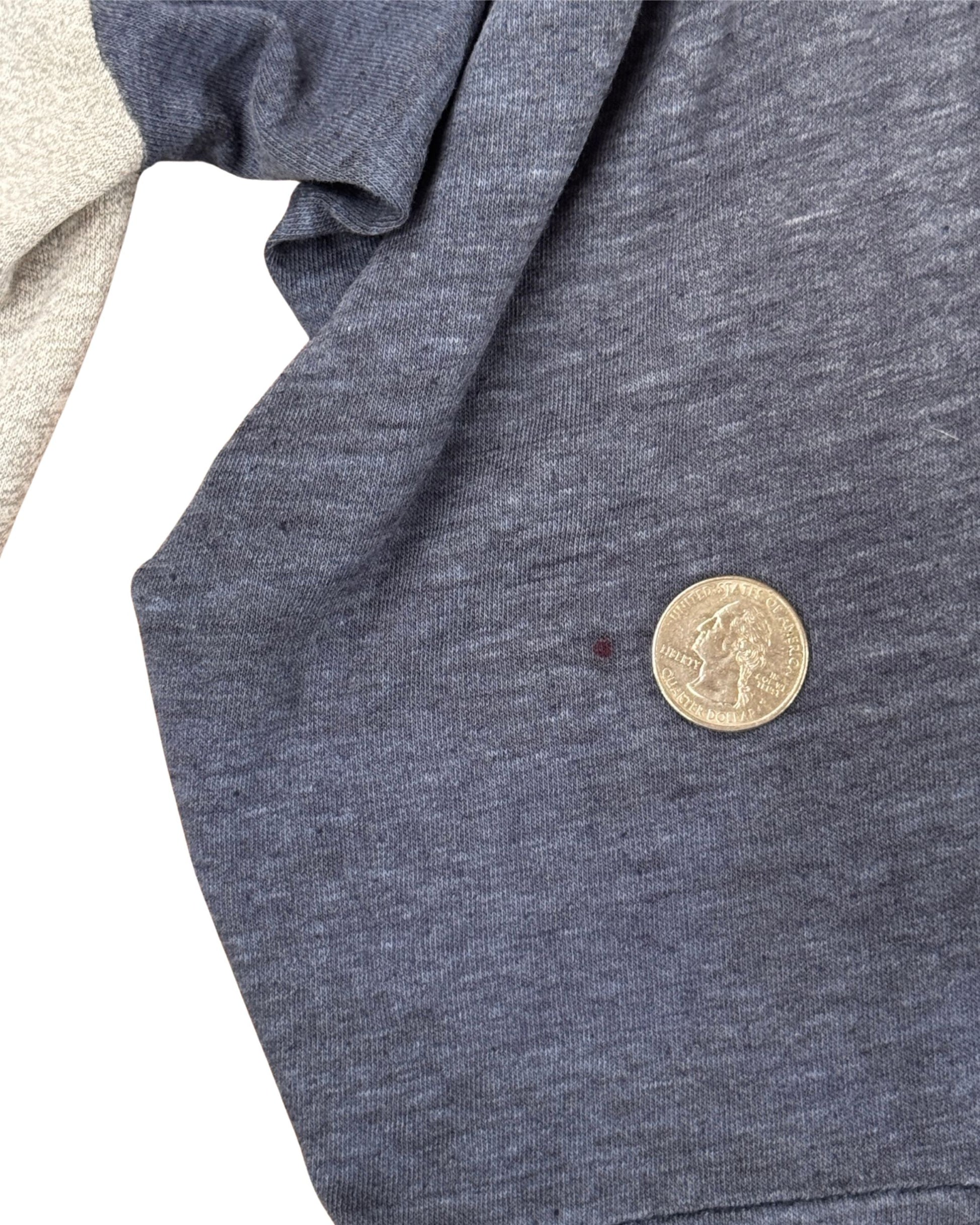Detail of small spot on sleeve of vintage T-shirt.