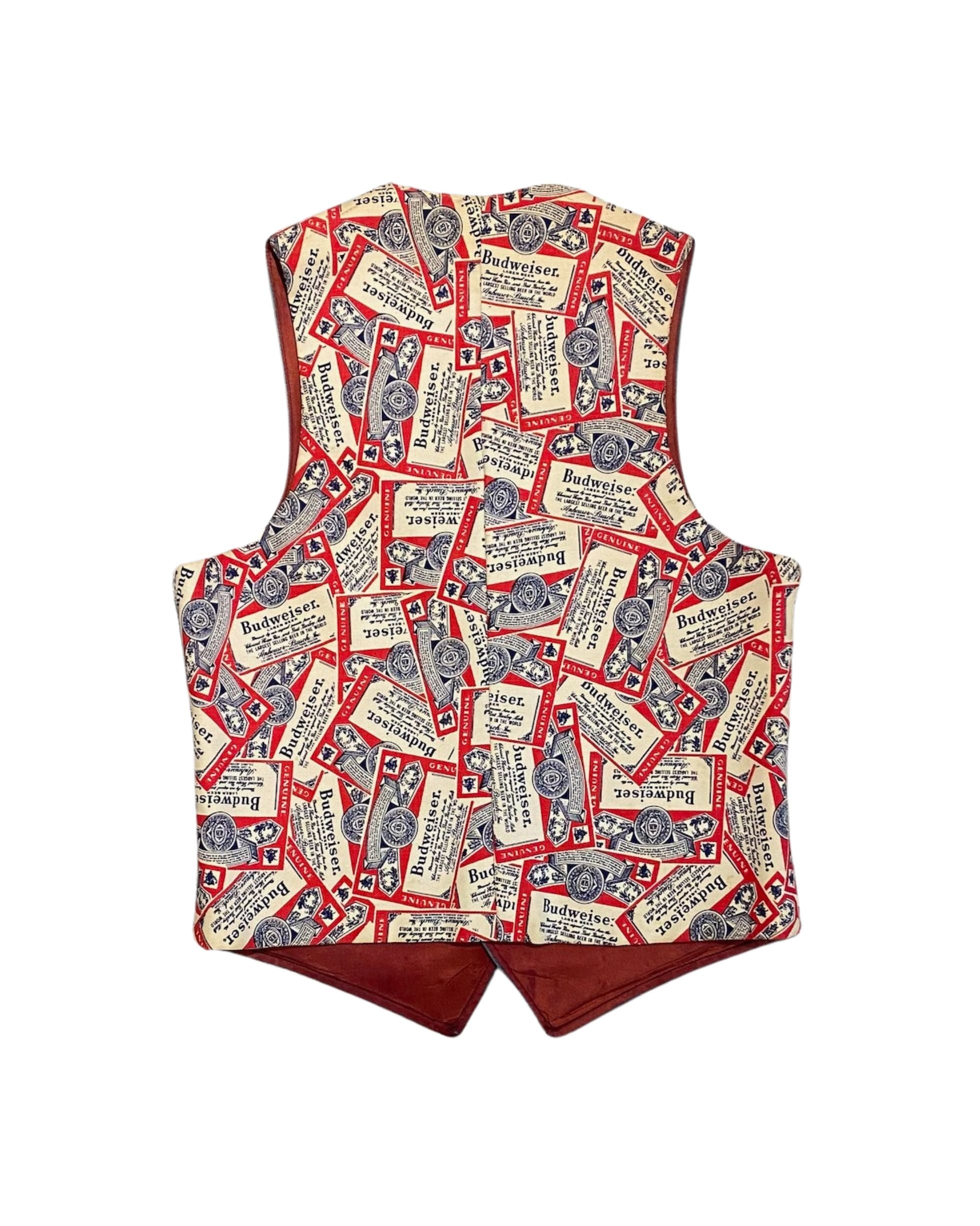 Back view of vintage Budweiser denim vest with all-over red cream and navy label print.