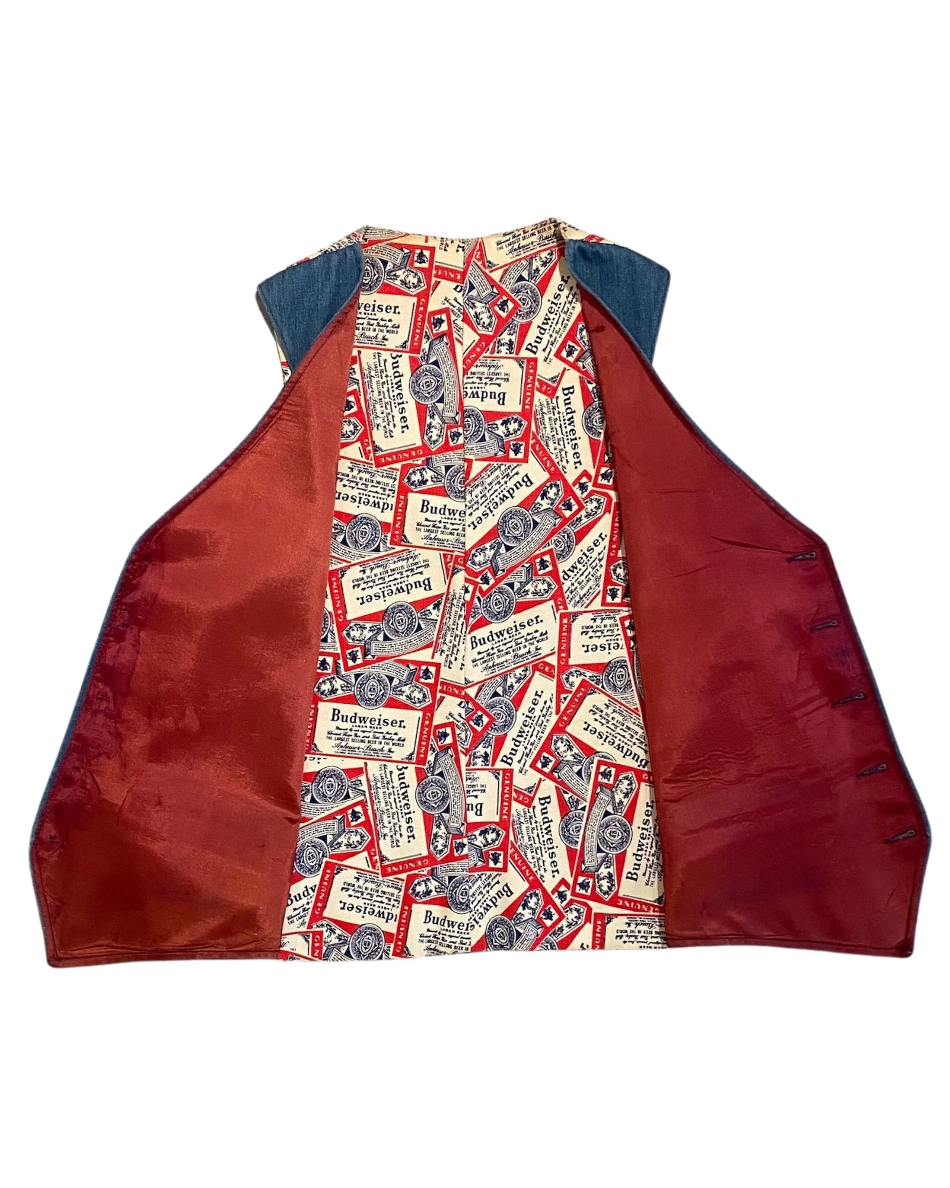 Interior view of vintage Budweiser vest showing printed lining and red satin-style panels.