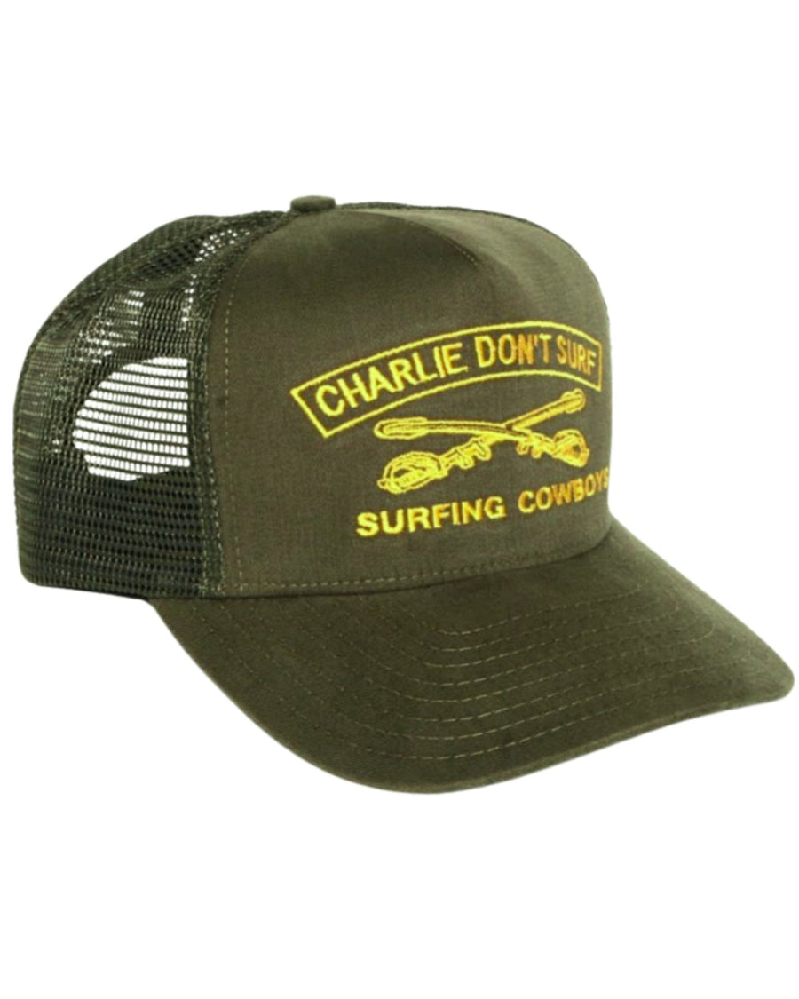 Surfing Cowboys Charlie Don’t Surf trucker hat in army green with gold embroidery, mesh back, and adjustable snapback closure.