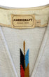 Close-up of the Americraft El Paso, Texas label and the woven fabric and geometric motif of the waistcoat.