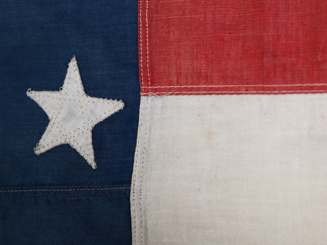 The upclose view of the stitching and star on the 45 Star American Flag from the Spanish American War, Era 1896-1906.