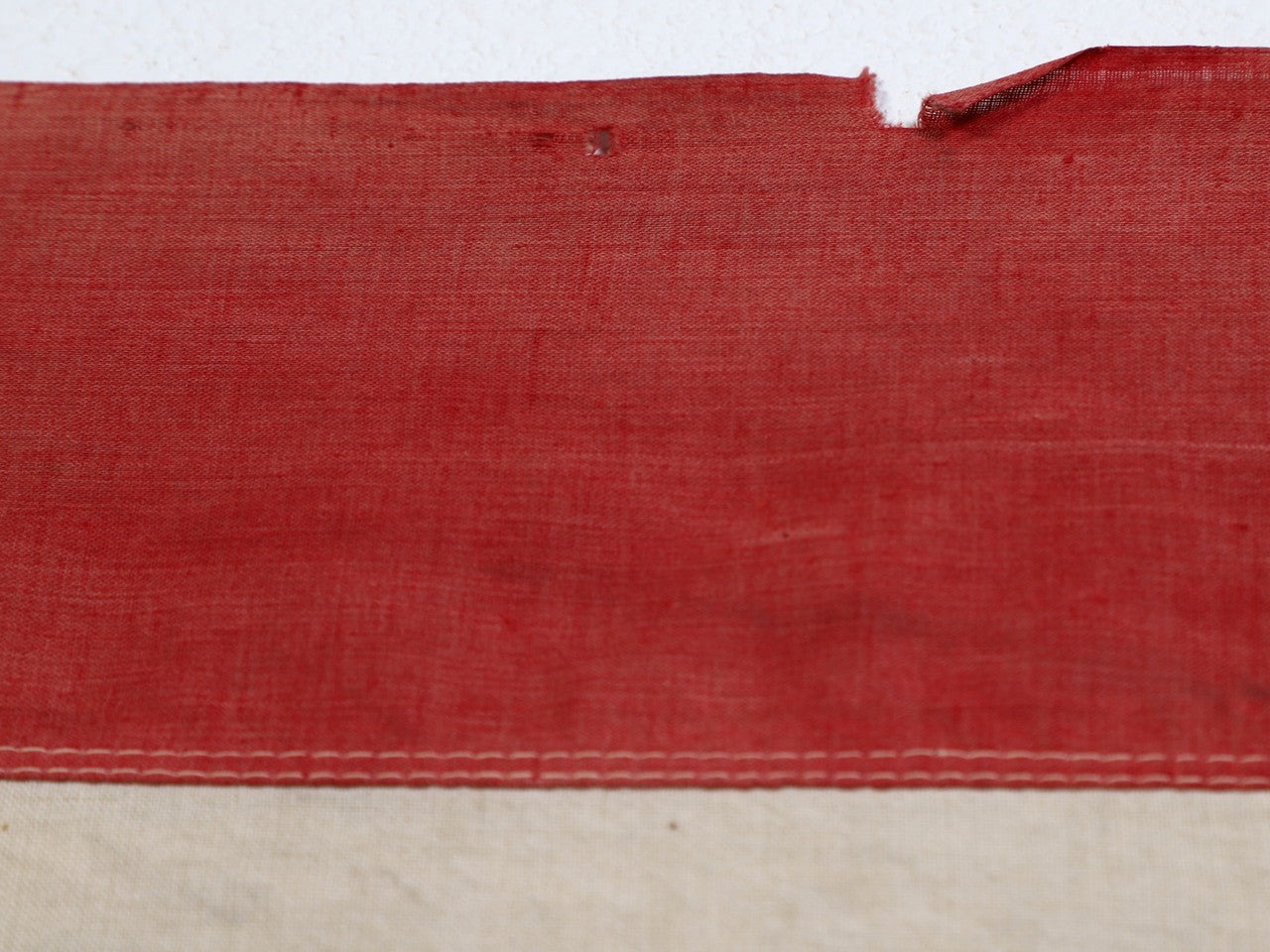 The upclose view of the red striped with small tear on the 45 Star American Flag from the Spanish American War, Era 1896-1906.