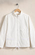 White jacket on a hanger against a beige background