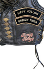 Close-up of Vintage Harley leather vest with 'Hippy Hollow Breezy Rider' and 'Harley Honey' patches.