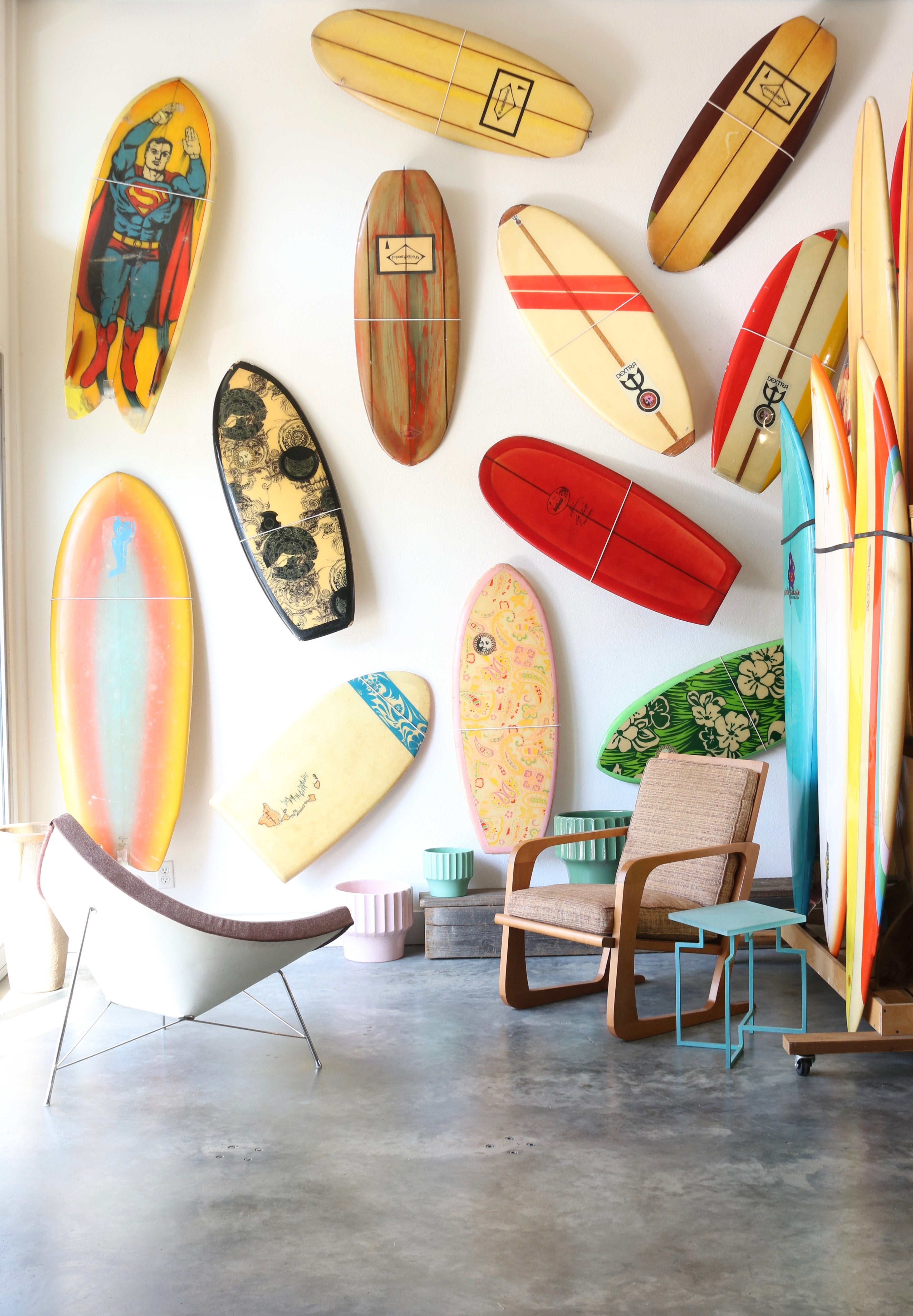 View Of Surfboards Mounted On Wall Indoors With Furniture 