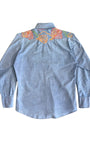 Back view of 1970s embroidered denim shirt showing colorful yoke detail.