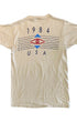 Back view of a beige Duran Duran T-shirt with 1984 USA lettering, red eye motif, blue geometric shapes, and horizontal line graphics.