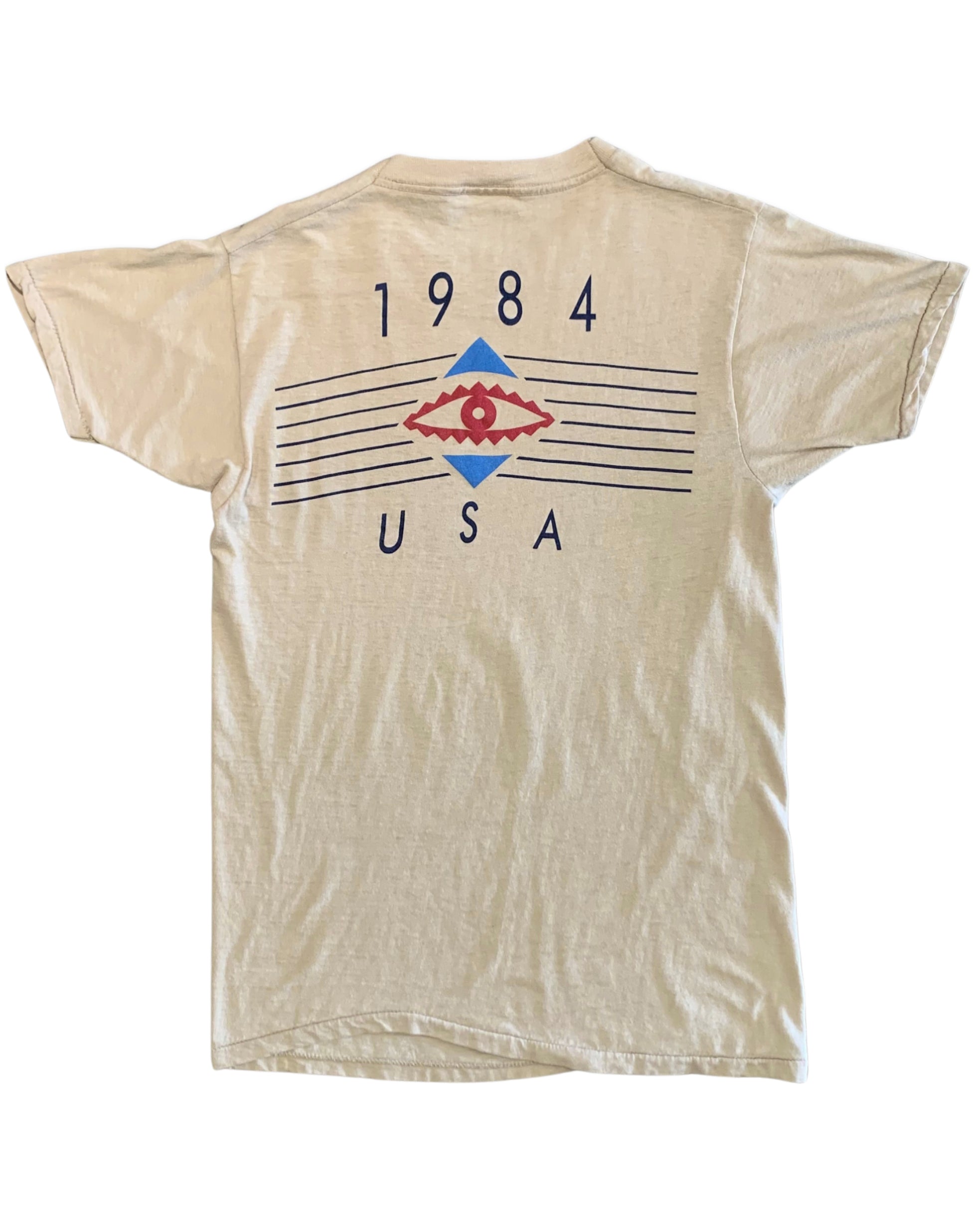 Back view of a beige Duran Duran T-shirt with 1984 USA lettering, red eye motif, blue geometric shapes, and horizontal line graphics.