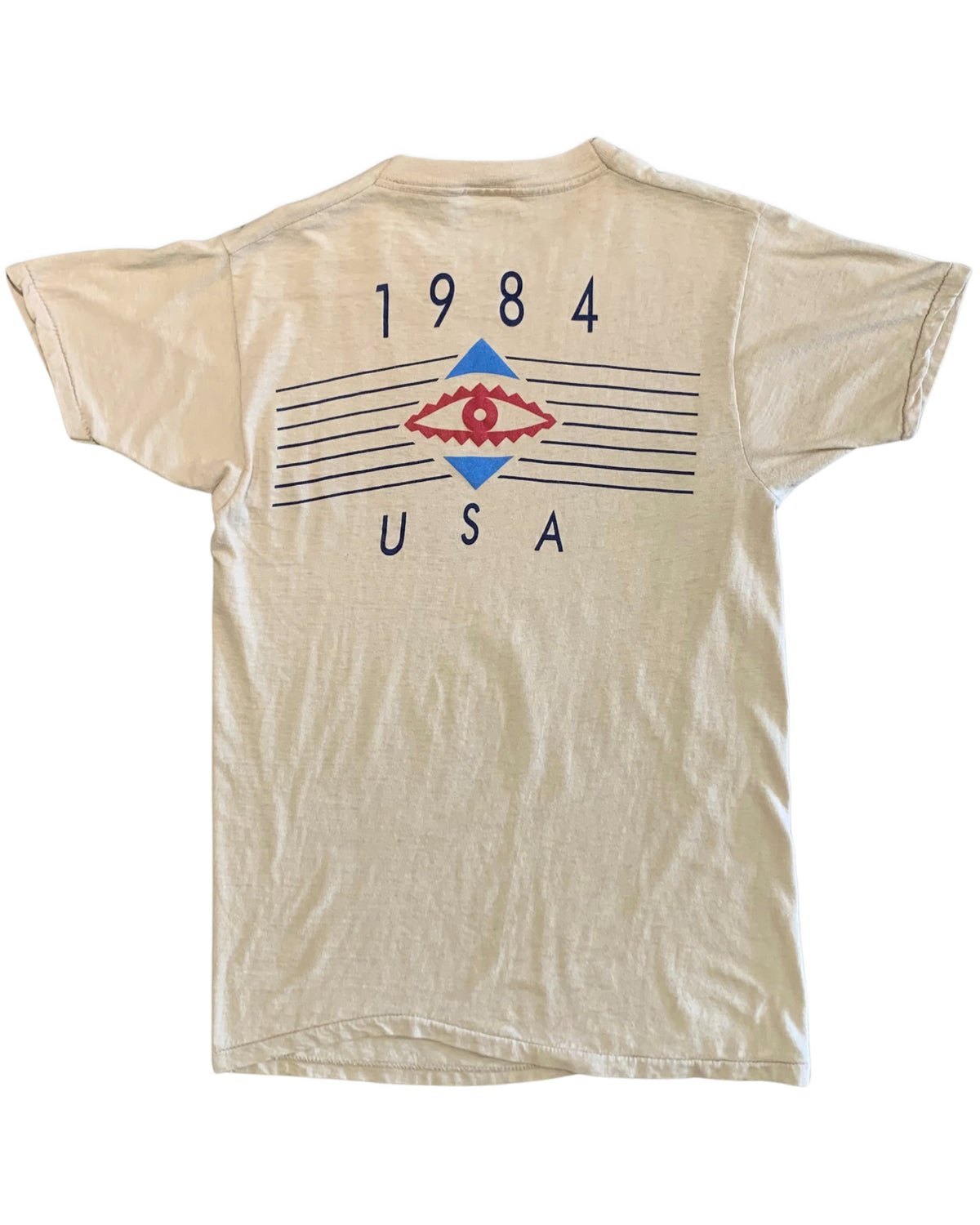 Back view of a beige Duran Duran T-shirt with 1984 USA lettering, red eye motif, blue geometric shapes, and horizontal line graphics.