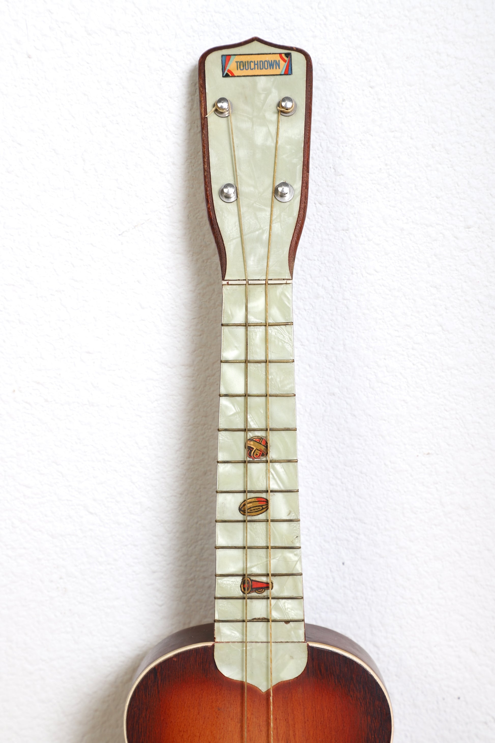 1920s Touchdown ukulele  faux pearl fretboard.