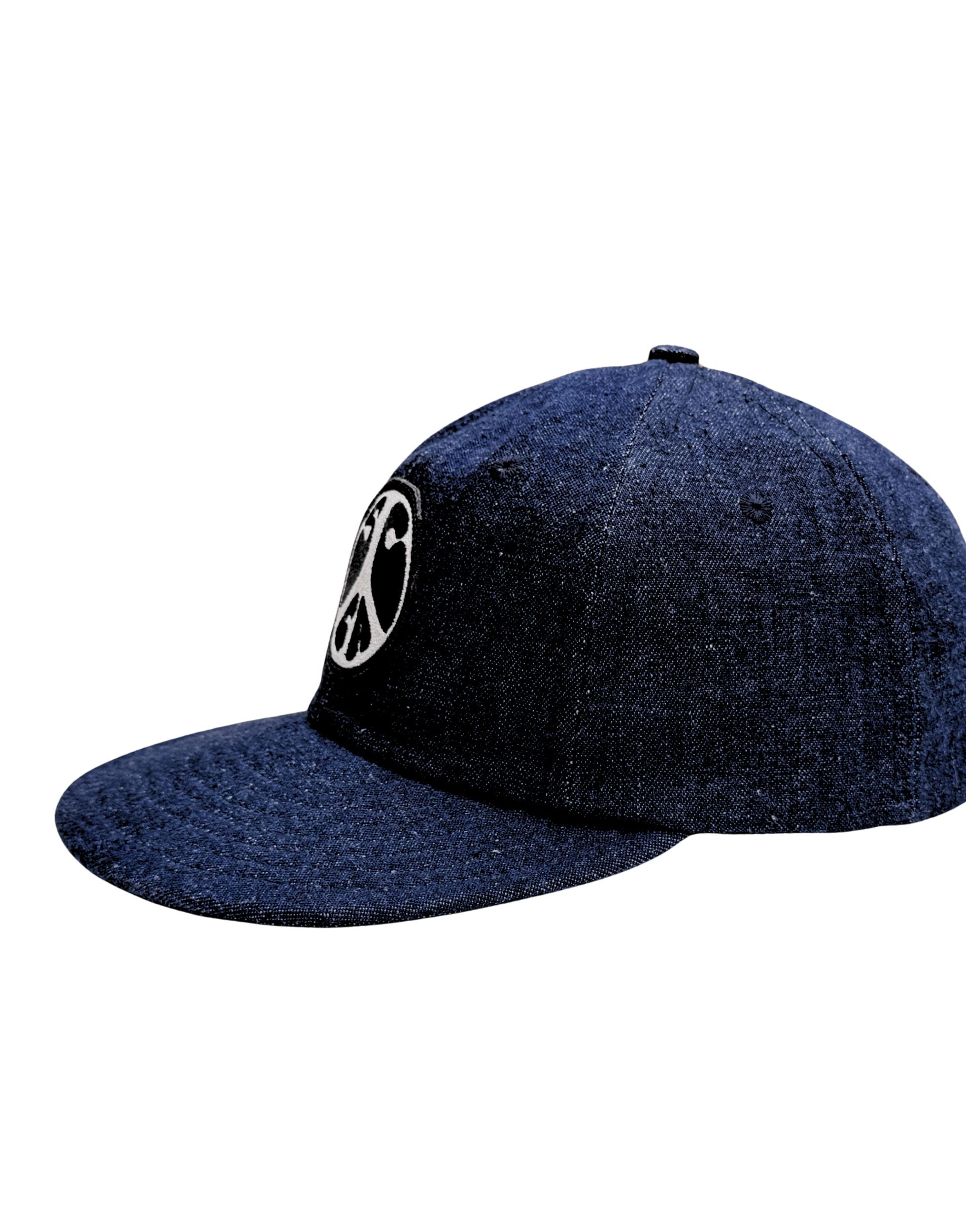 Side view of Surfing Cowboys Flex-Bill Peace Patch Shop Cap in dark denim.
