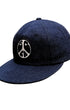 Upper angled view of Surfing Cowboys dark-denim Peace Patch Shop Cap with eight-row stitched bill.