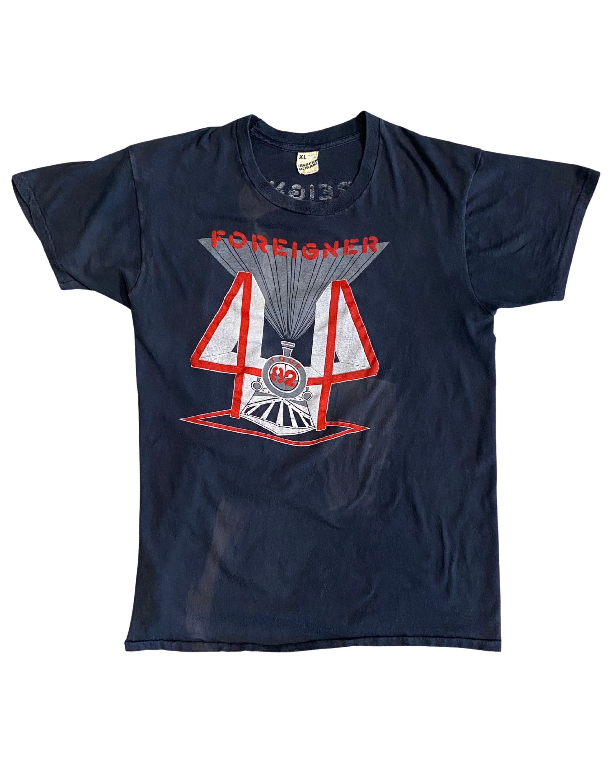 Front of black 1982 Foreigner concert T-shirt with red and white “4” locomotive graphic.