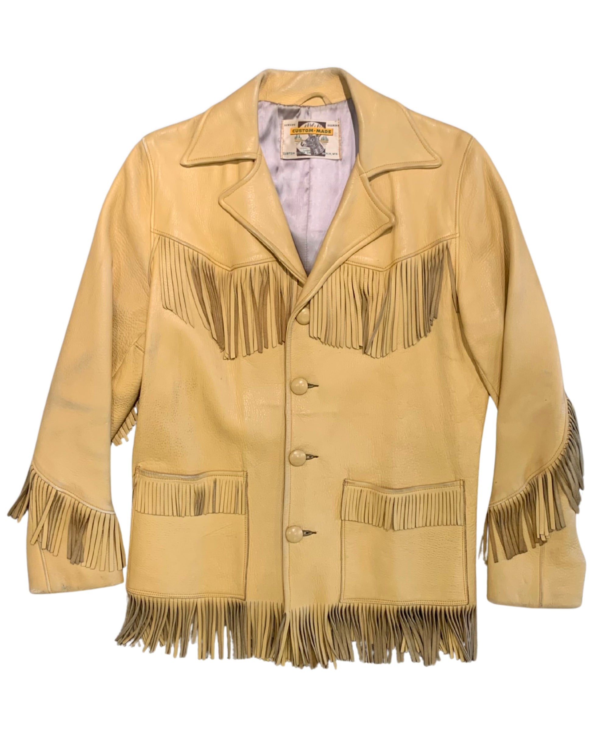 Front view of a butter tan deerskin jacket with fringe across the chest, sleeves, pockets, and hem.